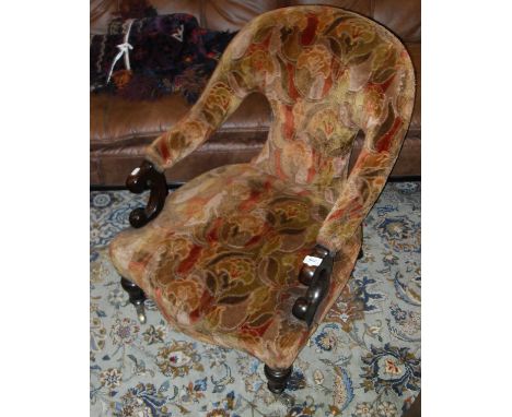 A Victorian mahogany framed salon chair with abstract tapestry style upholstery with serpentine front, raised on cabriole leg