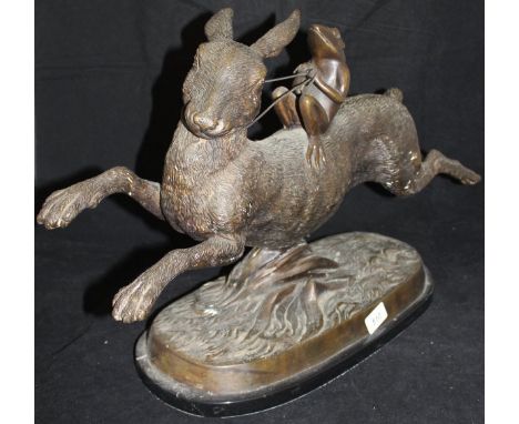A modern bronze study of a frog riding up on the back of a hare, on an oval black marble base   CONDITION REPORTS  Measures a