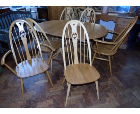 Ercol extending dining table and six chairs (two carvers). Condition reports are not available for the Interiors Sale.