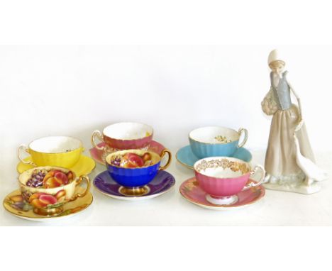 Six Aynsley cabinet cups and saucers also a Nao figure of a lady. Condition reports are not available for the Interiors Sale.