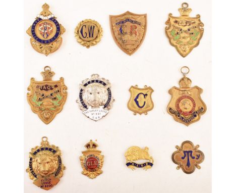 Twenty two gold plated base metal sash badges , together with a quantity of silver gilt and gold plated medals, sash bars and
