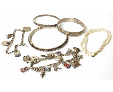 A quantity of silver jewellery comprising two charm bracelet, three bangles, also a freshwater pearl necklace with 9ct gold c