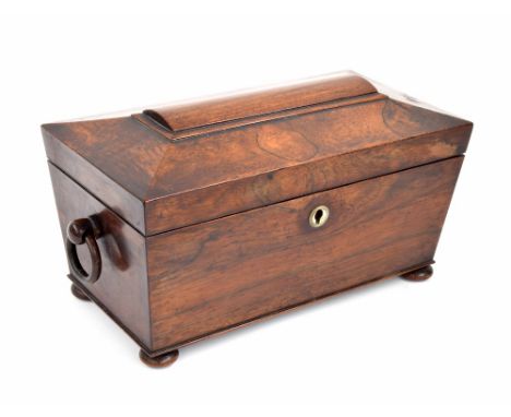 Victorian rosewood tea caddy of sarcophagus form, with ringed turned handles and a fitted interior inset with a moulded glass