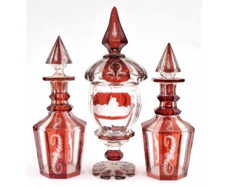 Pair of 19th century Bohemian ruby glass flash octagonal decanters, 12" high; together with a matching design vase and cover 