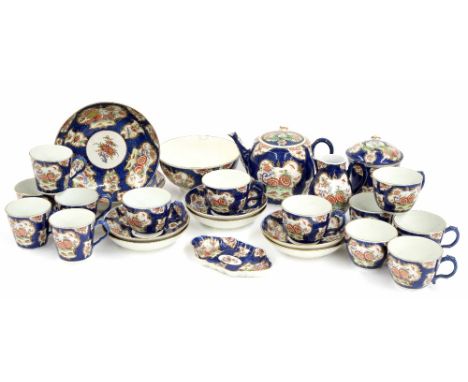 Extensive  Worcester porcelain tea service, late 18th century, painted with floral cartouche panels upon blue diaper grounds 