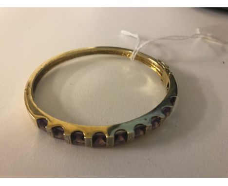 A 9ct amethyst and diamond set bangle