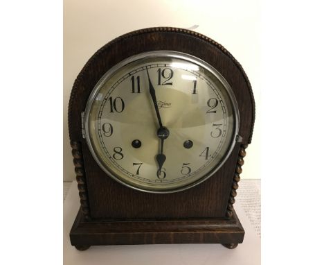 A 1920s oak Tima mantel clock striking on a gong