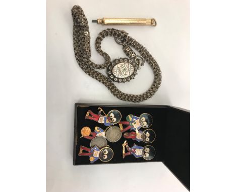 A Victorian silver chain and locket; together with Golly brooches and a gold-plated pencil