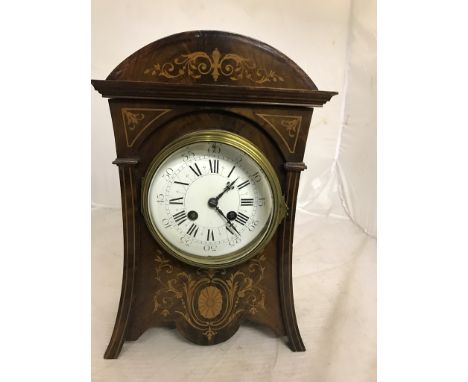 A Victorian mahogany mantel clock with inlaid panels