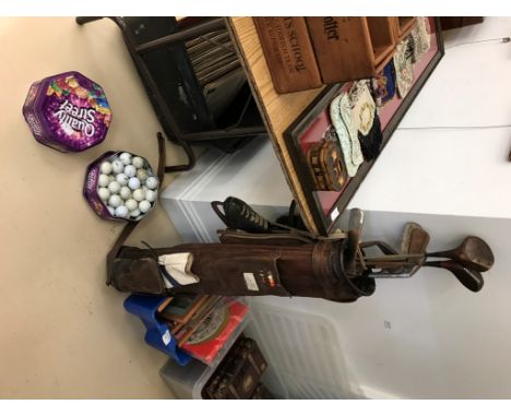 A quantity of vintage golf clubs, balls and skates