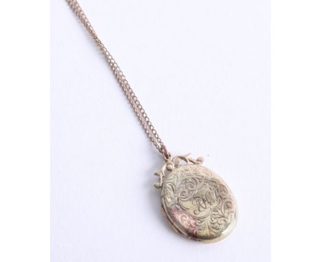 A 9ct locket and chain (dent).