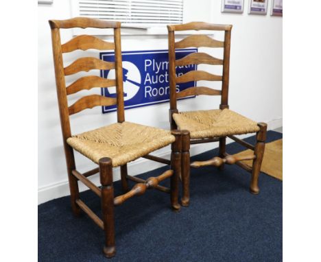 Two similar ladder-back and rush seated side chairs.
