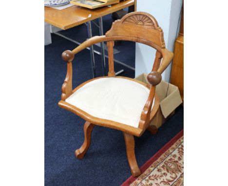 A light oak captains office swivel armchair.