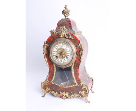 A 19th century Boulle clock, enamel cartouche dial, pendulum, gold strike and gilt mounts, height 35cm.