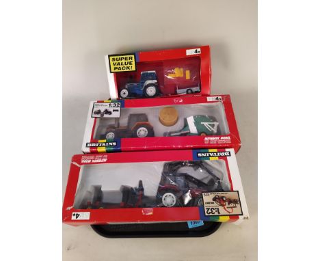 Three boxed Britains 1:32 scale models including 9656 Renault TX16 tractor and baler, 9627 Valmet logging tractor and trailer