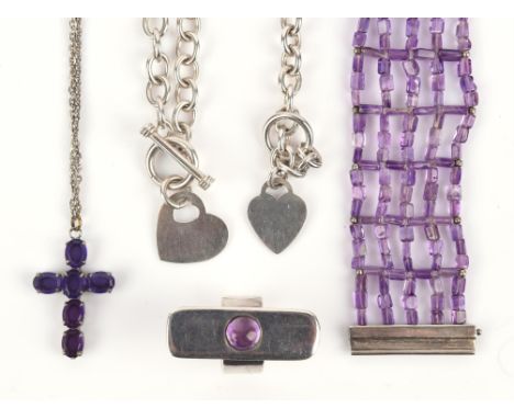A group of amethyst jewellery, including an amethyst bead bracelet, a ring, and a cross together with a heart necklace with a