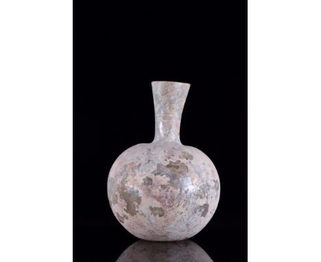 Ca. 1-400 AD.A free-blown clear glass flask featuring a spherical body on a concave base with a pontil scar, a funnel-shaped 