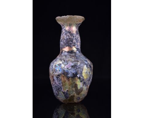 Ca. 100-300 AD.A Roman glass flask featuring a bulbous body, gently tapering to a base, a long, tubular neck, and a wide mout