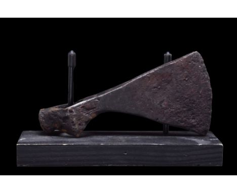Ca. 1000 AD.A forged-iron axe head with a perforated socketing shaft, a dense neck, and a vertically oriented blade with gent