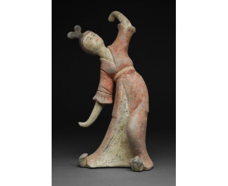 Tang Dynasty, Ca.618-907 AD.A terracotta Tang Dynasty female dancer wearing a long flowing gown with her hands uncovered. The