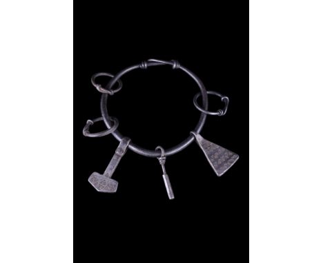Ca. 900-1100 AD.A silver bracelet composed of a round-section shank with its tapering ends twisted together. The bracelet com