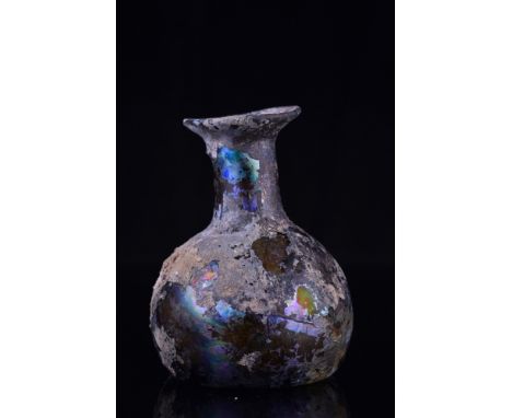 Ca. 100-300 AD.A beautiful glass flask with a globular body, a flaring cylindrical neck, and a wide mouth with a slightly eve