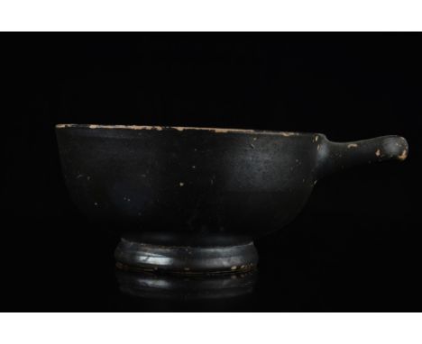 Ca. 2nd half 4th - 1st half 3rd Century BC.A deep cup on a wide ring foot featuring a lustrous black glaze and a looped handl