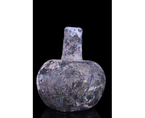 Ca. 100-300 AD.A glass flask with a tubular neck and bulbous-shaped lower body with a broad shoulder and a concave base. Some