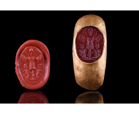 Ca. 100-200 AD.A red stone intaglio engraved with a central tropaion, the war trophy flanked by two kneeling figures of capti