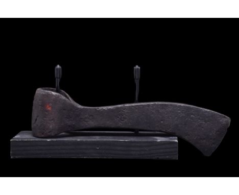 Ca. 900-1100 AD.An iron axe head comprising a long, curved blade, elongated cheek, lozenge-shaped poll and a round socket. Fo