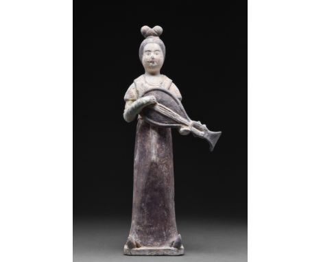 Ca. 618-907 AD.A mould-formed pottery tomb attendant figure in the form of a woman who is wearing a long robe with a red-pain