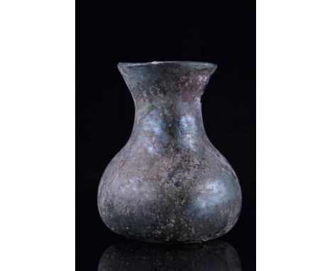 Ca. 100-300 AD.A beautiful glass flask with a globular body, a flaring cylindrical neck, and a wide mouth with a slightly eve