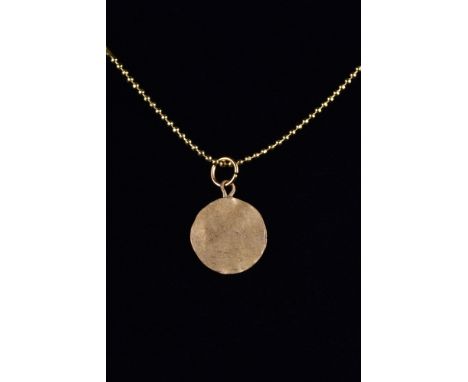 Ca. 200-300 AD.A finely rendered gold disc-shaped pendant, hammered from thin gold with a suspension loop. This piece is full