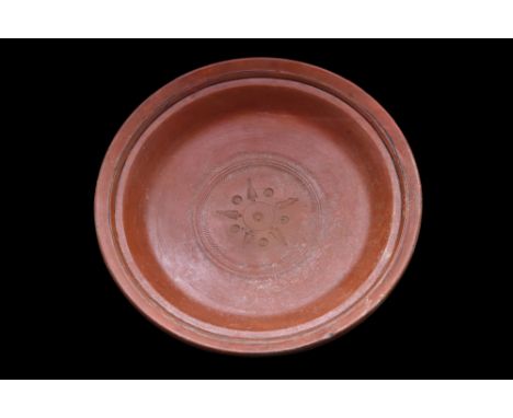 Ca. 300-400 AD.A finely made wheel-thrown redware pottery dish, with a squat form that rests atop a low ring base. The dish i