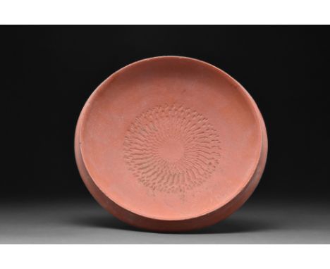 Ca. 1-300 AD.A terra sigillata bowl with a hemispherical body rising from the low foot ring. The interior with graver decorat