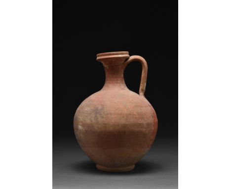 Ca. 100-300 AD.A pottery vessel in the form of a jug /flagon with a bulbous-shaped body, nicely tapering to a ring base. It f