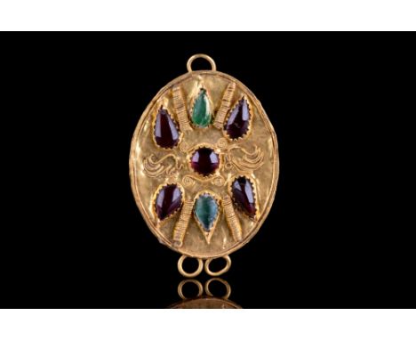 Ca. 300 BC.A gold pendant plaque with granulated rim and applied opposing loops. The upper face intricately decorated with fi