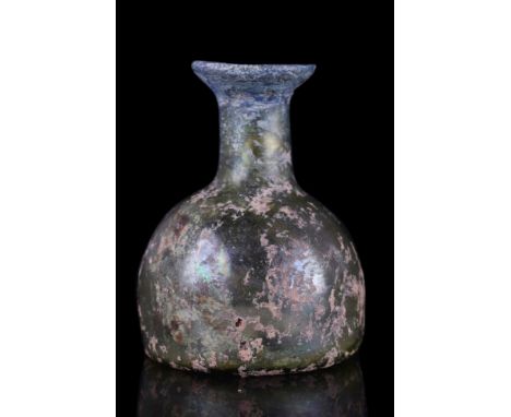 Ca. 100-300 AD.A free-blown glass flask of a dome-shaped body, concave base with a pontil mark, tubular neck with everted rim