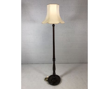 Dark mahogany stained circular based standard lamp