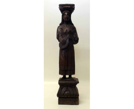 16th Century style carved oak caryatid lute player. Condition report: see terms and conditions.