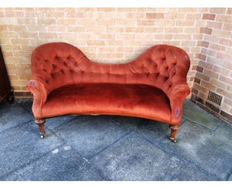 A VICTORIAN BUTTON UPHOLSTERED SOFA  with shaped back on turned and fluted front supports, stamped to back legs 'HOLLAND & SO