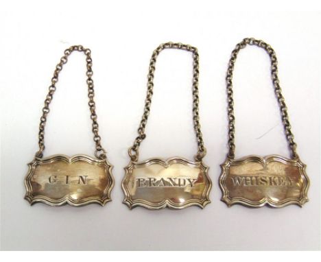 A SET OF THREE VICTORIAN SILVER WINE LABELS by Riley and Storer, London 1840, of rectangular shaped outline with moulded rims