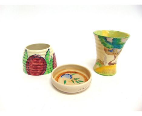 THREE ITEMS OF CLARICE CLIFF:  a Bizarre ware honey pot (lacking lid) decorated in the 'Gloria' pattern, 6.5cm high; a Bizarr