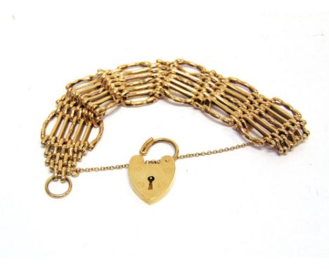 A BRACELET of fancy seven bar gate link design, to a 9 carat gold padlock clasp, 28g gross