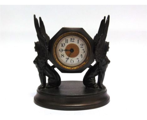 A LATE 19TH / EARLY 20TH CENTURY PATINATED METAL MANTEL CLOCK the circular dial with a white chapter ring and black Arabic nu