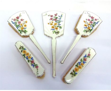 A SILVER AND ENAMEL FIVE PIECE DRESSING TABLE SET London 1952, the hand mirror, two hair and two clothes brushes enamelled wi