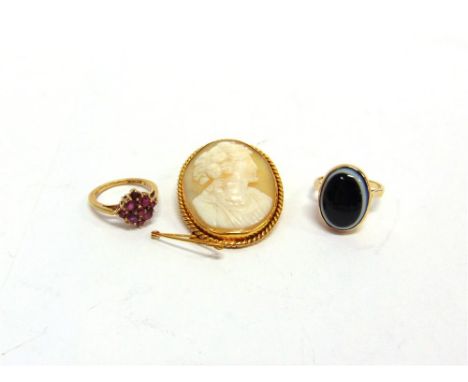 A SHELL CAMEO BROOCH in a mount tagged '9ct'; a banded onyx ring stamped '9ct'; and a 9 carat gold ruby cluster ring; 13g gro