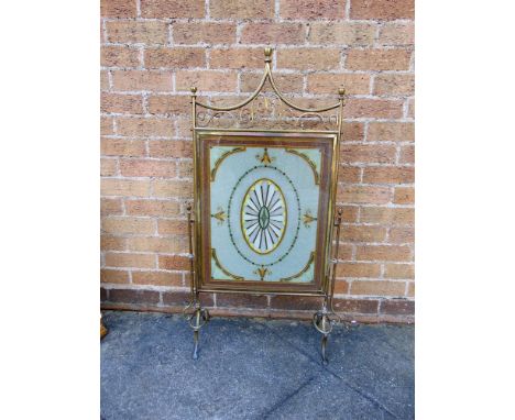 AN EDWARDIAN BRASS FRAMED FIRE SCREEN  with glass beadwork panel, 60cm wide 104cm high overall