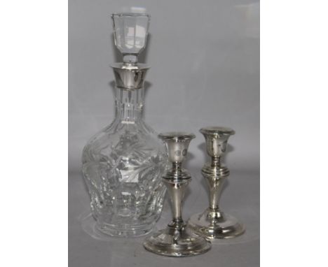 A decanter and a pair of silver candlesticks