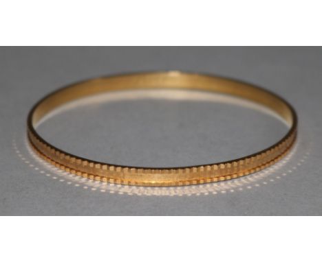 An Arabic gold bangle.